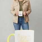 Bree holding the Messy Action mug, owning the moment and pushing the message that clarity comes from movement, not perfection.